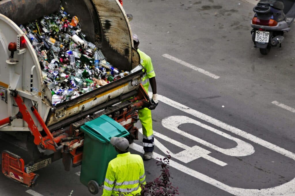 Commercial waste collection showing a refuse collector and bin lorry